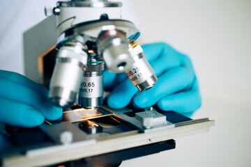 Microbiologist using laboratory microscope