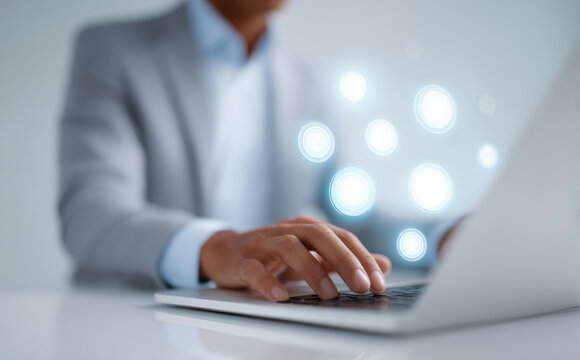 Focused businessman typing on laptop, using modern digital technology for work. close up on hand illustrating business network and online connection concept