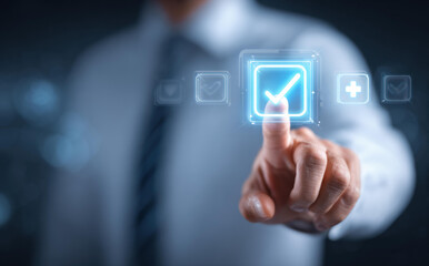 Focused businessman using finger to touch virtual checkbox with glowing tick. Man making choice to select, confirm, and approve digital task for business success