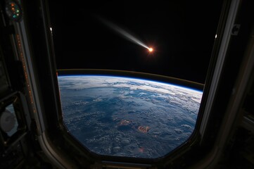 Fototapeta premium Comet rising above Earth’s curved horizon viewed through Space Station window reflection
