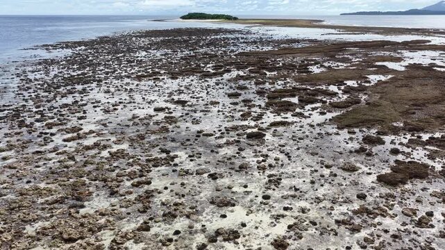 Low tide exposes corals at the historic island of Ruhn in the remote Banda Islands of Indonesia. This region is home to spectacular marine biodiversity and is a destination for divers and snorkelers.