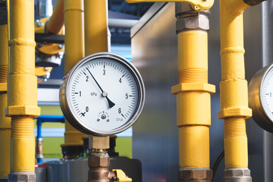 High pressure gauge connected to water supply system pipes, industrial concept