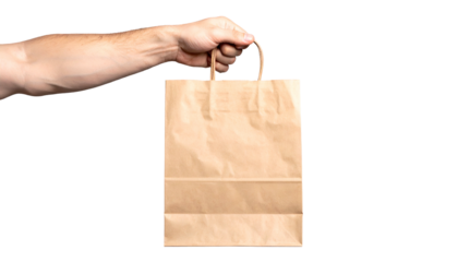 A hand holds a brown paper shopping bag against a black background