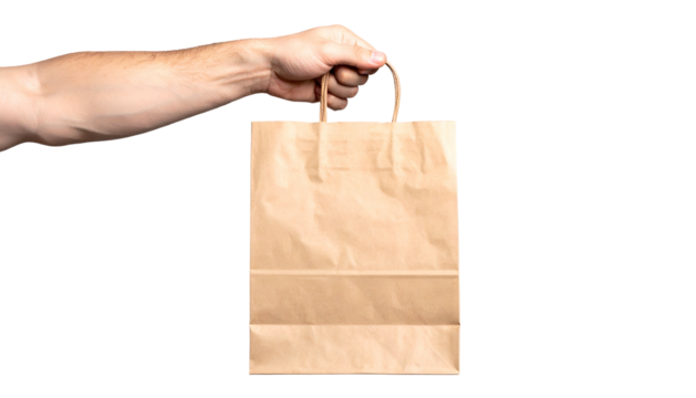 A hand holds a brown paper shopping bag against a black background