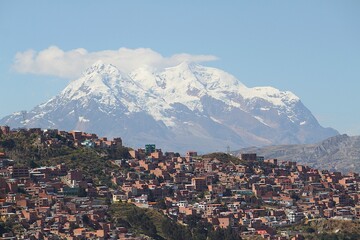 La Paz, Bolivia: Panoramic urban view from mountain top of Mirador de Killi Killi lookout terrace. Impressive snow-covered Illimani in vicinity of capital city.