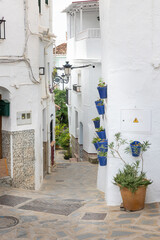 Fototapeta premium Houses in the narrow alleys of the white village Competa, Spain, Andalusia