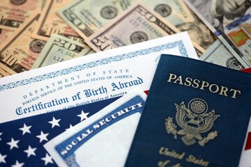 Certification of Birth Abroad with US flag, social security number and passport on US dollar money bills close up