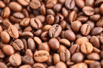 Textured background of freshly roasted coffee beans close up