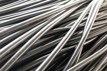 Detailed view of plastic pipes arranged in chaotic yet organized manner, showcasing the smooth texture and reflective surfaces, highlighting the industrial environment and craftsmanship