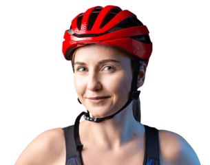 A young female cyclist wearing a safety helmet and glasses, dressed in a bib shorts poses against a black background in the studio.