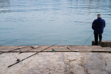  A fisherman fishes in the port of Batumi on a winter day in January.