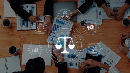A collaborative business meeting focused on legal issues, featuring hands over charts and graphs, with digital visuals of balance scales and reports illustrating teamwork. Raster - Powered by Adobe