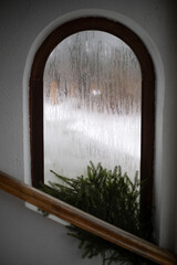 Fogged window. Beautiful window in a white wall.