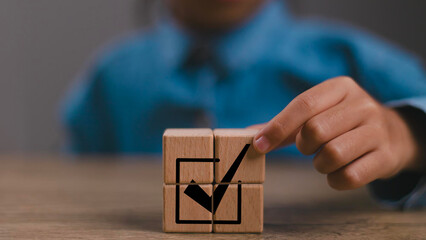 Corporate regulatory and compliance. Goals achievement and business success. Task completion. Ethical corporate. Do the right thing. Quality and ISO symbol. Placing wooden cube with checkmark icon.