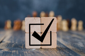 Corporate regulatory and compliance. Goals achievement and business success. Task completion. Ethical corporate. Do the right thing. Quality and ISO symbol. Placing wooden cube with checkmark icon.