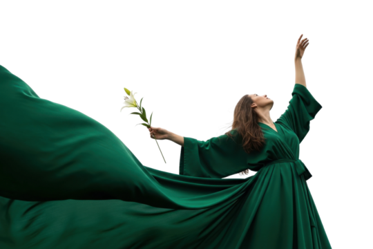 An elegant woman in a flowing green gown holds a lily while reaching towards the sky