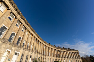 Historic curved architecture under blue sky
