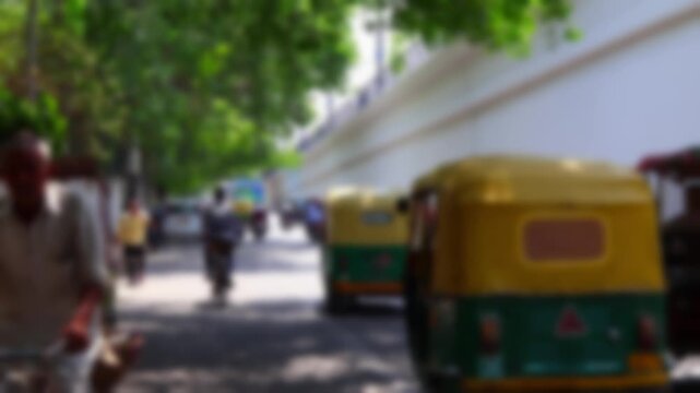 Blurry view of vehicle daytime traffic near Connaught Place in Delhi, india. Bokeh real time motion video for background.