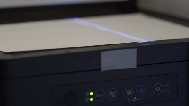 Data Captured Quickly: Scanner Buzzes Loudly as Blue Light Moves to Digitize Document