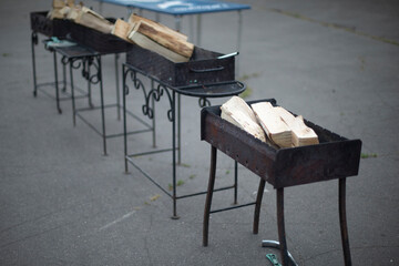 Firewood for outdoor cooking. Preparing a picnic in the city. Site for making a fire.
