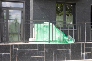 A bag outside the house. Construction debris near the entrance to the building.