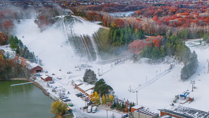 Aerial photography of  the interaction between late autumn and early winter at Hyland Ski Hill