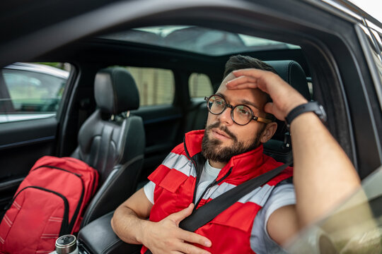 Stressed paramedic man experiencing burnout in car - Powered by Adobe