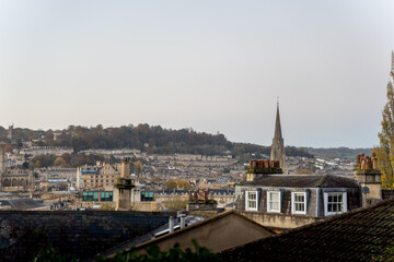 Fototapeta premium Distant town rooftops under misty sky
