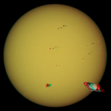 Saturn compared to the Sun. 3D anaglyph image to view with red/cyan glasses.