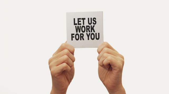 Let Us Work For You. Closeup Business man hand holding show blank paper sheet mock up empty white board space for shouting text rule or protest word. Text let us work for you.