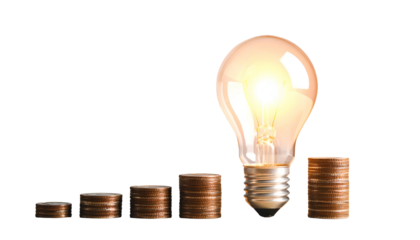 Glowing light bulb atop rising coin stacks symbolizing financial growth and bright ideas