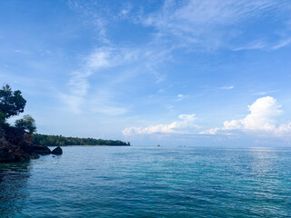 Discover paradise on an exotic tropical beach with calm turquoise water and a beautiful blue sky landscape