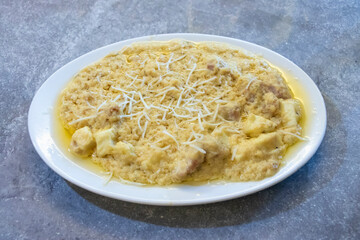 Chicken cheese butter masala steamed egg dish, perfectly topped with delicate shredded cheese for a delightful culinary experience. Ideal for any meal.