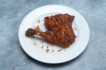 fried chicken tikka, a golden masterpiece on a clean white plate, inviting culinary delight.