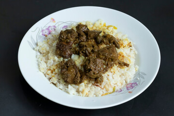 savory Kolija Polao stewed liver and offal dish beautifully presented over fluffy white rice a truly comforting and delicious culinary experience.