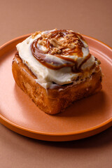 Cinnabon, a sweet cinnamon pastry, a high calorie bun or roll. Cinnabon with cinnamon