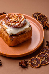 Cinnabon, a sweet cinnamon pastry, a high calorie bun or roll. Cinnabon with cinnamon