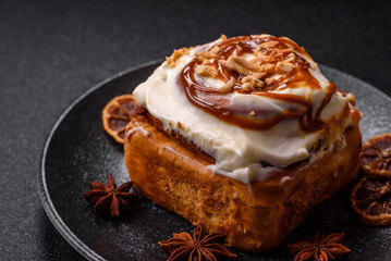 Cinnabon, a sweet cinnamon pastry, a high calorie bun or roll. Cinnabon with cinnamon