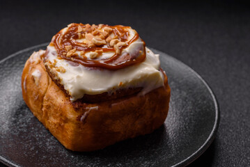 Cinnabon, a sweet cinnamon pastry, a high calorie bun or roll. Cinnabon with cinnamon