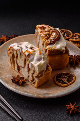 Cinnabon, a sweet cinnamon pastry, a high calorie bun or roll. Cinnabon with cinnamon