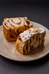 Cinnabon, a sweet cinnamon pastry, a high calorie bun or roll. Cinnabon with cinnamon