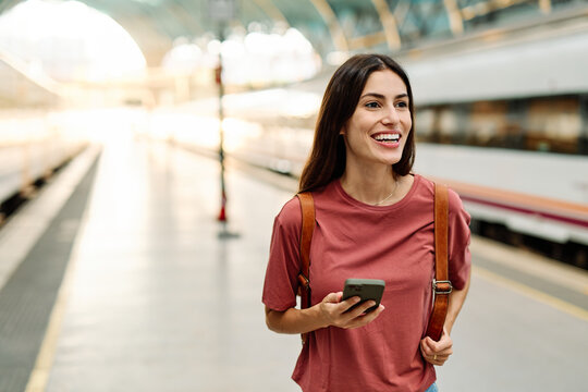 Young Woman Using Phone In A Subway Station
