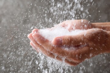 Fototapeta premium Captivating Moment of Water and Soap Bubbles Creating a Beautiful Scene in Hands, Symbolizing Cleanliness, Care, and Freshness