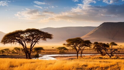 african savannah with river trees and mountains on the horizon
