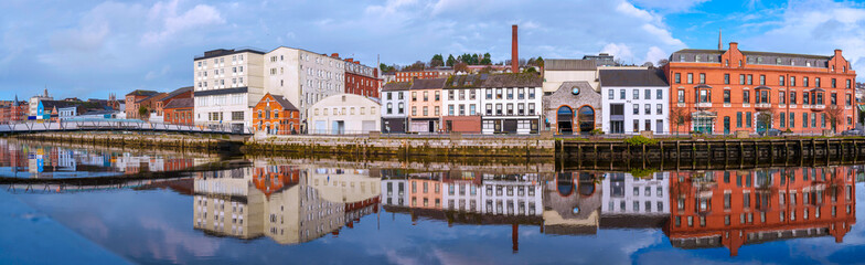 Cork City skyline with landmark architecture and water reflections on the River Lee in Ireland, a...