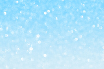 Abstract blue and white bokeh light snowfall background. New Year, Christmas, Winter and all celebration background concept.