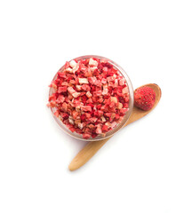 Glass bowl and spoon with dry strawberries top view on white background