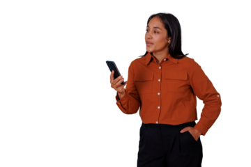 Woman holding smartphone browsing device and looking away, standing with hand in pocket, transparent background