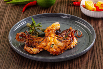 Gourmet grilled whole octopus served lime