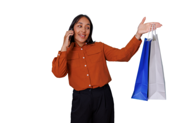 Happy young woman talking on mobile phone while carrying shopping bags, smiling and looking away. Transparent background